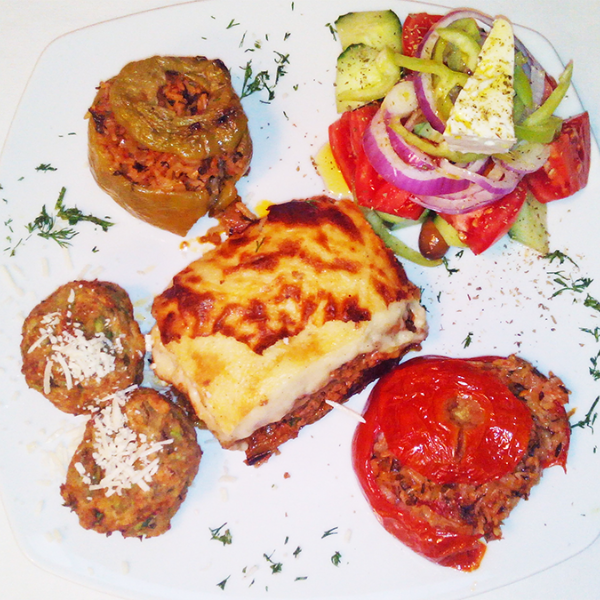 Traditional Greek moussaka, stuffed peppers (gemista), greek salad, zucchini patties